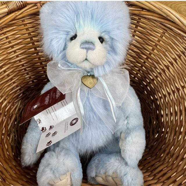 Gaynor Charlie Bears Charlie Bears Gaynor plush bear sitting inside a wicker basket with tags attached