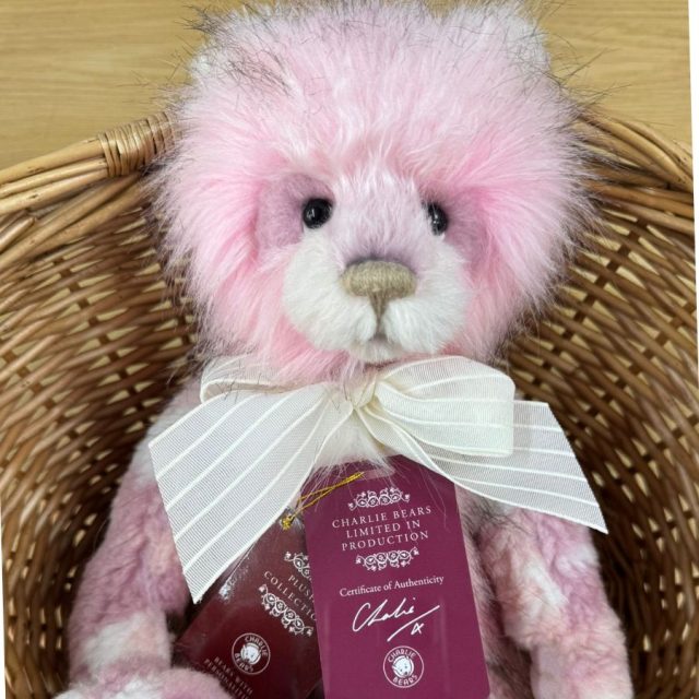 Julia Charlie Bears Close-up of Charlie Bears Julia pink plush bear wearing white bow with tags