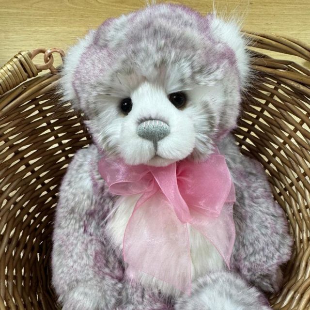 Plush Collection Amelia Charlie Bears Amelie plush bear seated in wicker basket showing soft grey and white fur