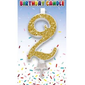 Gold glitter number 2 birthday cake candle with holder on colourful confetti background