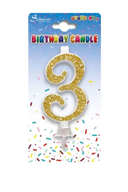 Gold glitter number 3 birthday candle on card packaging with confetti