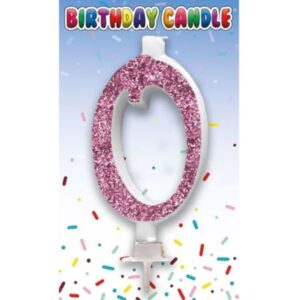 Pink glitter birthday candle in the shape of number zero on retail card