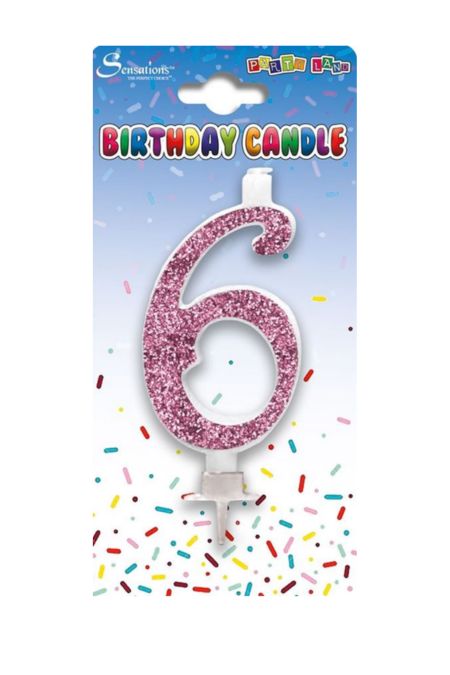 Pink glitter birthday candle shaped as the number 6 in packaging