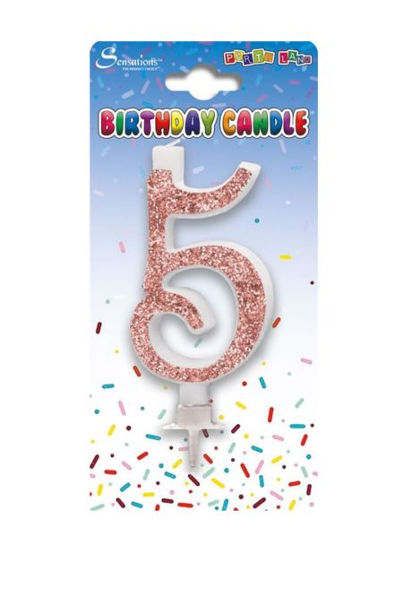 Rose gold glitter number 5 birthday candle on white card with multicoloured sprinkles background