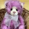 Close-up of Charlie Bears Shortcake raspberry pink plush bear face with organza bow