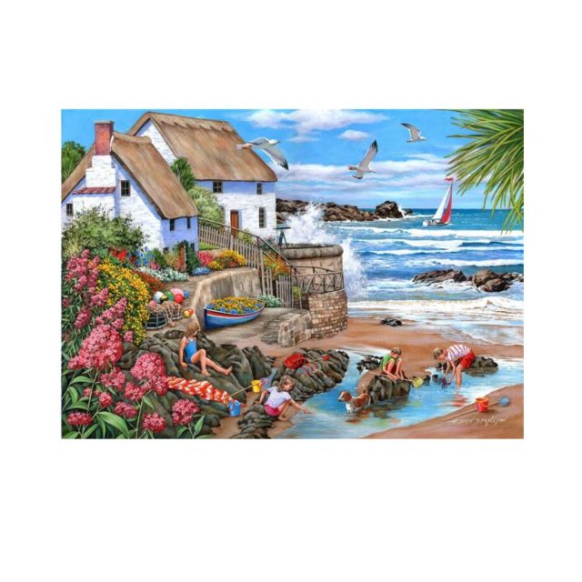 House of Puzzles Seaspray Cottages Seaspray Cottages 1000 piece jigsaw showing children playing by a seaside cottage and beach