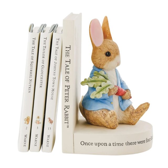 Side view of Peter Rabbit book stop supporting multiple books on a shelf