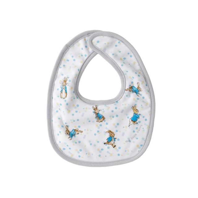 White baby bib with grey trim and multiple small Peter Rabbit designs with blue jacket