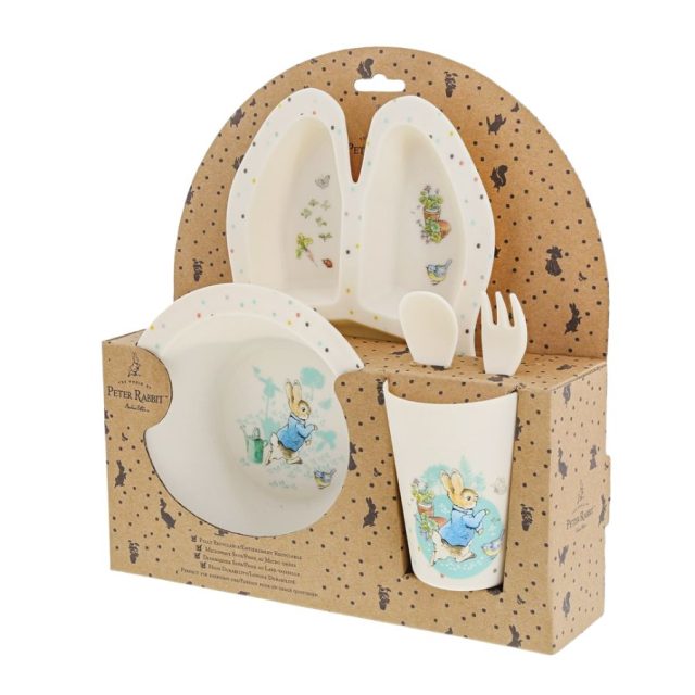 Side view of Peter Rabbit baby dinner set featuring divided plate, bowl, cup and utensils in packaging