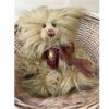 Charlie Bears Tater Tot sitting in wicker basket with tag and dark brown organza bow
