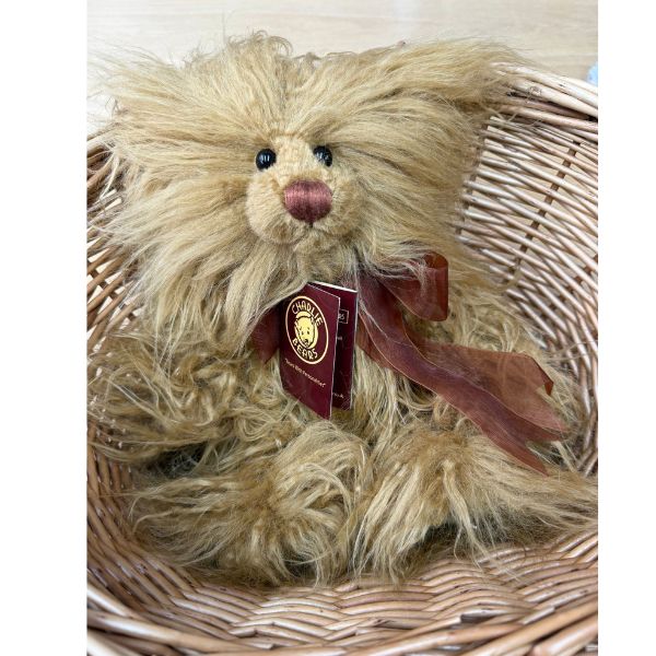 Charlie Bears Tater Tot sitting in wicker basket with tag and dark brown organza bow