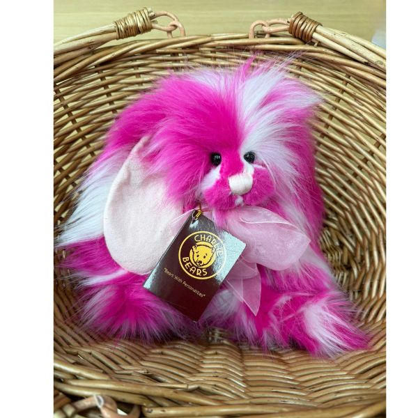 CB256122O Raspberry Ripple Charlie Bears Raspberry Ripple sitting in a woven basket showing vibrant pink and white fluffy fur