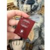 Close-up of Charlie Bears JD plush bear showing Plush Collection tag with hand