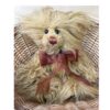 Close-up view of Charlie Bears Tater Tot showing dark brown organza bow and expressive eyes