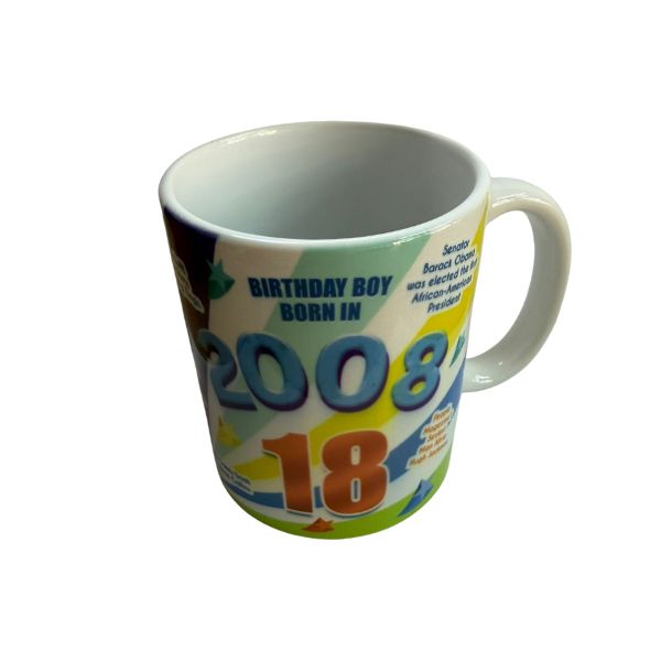 Close-up of white ceramic mug with 2008 and 18th birthday flashback design on one side