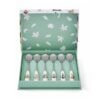 Tea spoons neatly arranged in a decorative gift box with a green interior and animal pattern on the lid