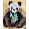 Botwood Charlie Bears Charlie Bears Botwood plush panda sitting in wicker basket with green ribbon