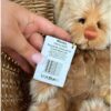 Close-up of Charlie Bears Monday teddy bear tag showing product details and barcode
