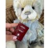 Charlie Bears CB242404B Close-up of Charlie Bears Edyta plush panda with tag displaying collection details