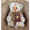Charlie Bears Monday plush teddy inside basket with Charlie Bears branded tag attached