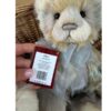 Edyta CB242404B Close-up view of Charlie Bears Edyta plush panda with care and design tag held next to bow