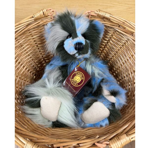 Miss Liddell Charlie Bears Miss Liddell plush bear with label seated in a wicker basket