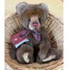 Charlie Bears Mr Brown plush bear in wicker basket showing burgundy bow and tag