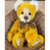 Charlie Bears Mrs Jones bear nestled in a wicker basket showing soft white inner ears and contrasting muzzle