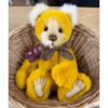 Close-up of Charlie Bears Mrs Jones bear in wicker basket highlighting hand-embroidered nose and detailed paws