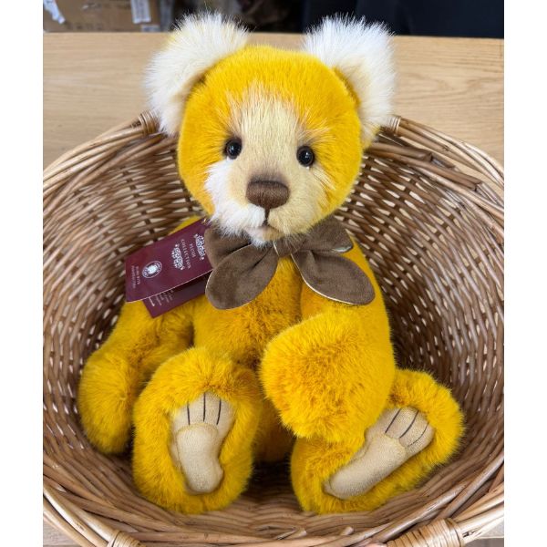 Close-up of Charlie Bears Mrs Jones bear in wicker basket highlighting hand-embroidered nose and detailed paws