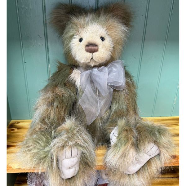 Rosa Charlie Bears Charlie Bears Rosa plush bear sitting on wooden surface with silver-grey bow