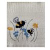 Riggs Bees in Meadow Gift Box Tea Towels-1 Close-up of cream Riggs Bees in Meadow tea towel with embroidered bees and small blue and yellow flowers