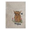 Detailed close-up of embroidered Angus cow on cream Riggs tea towel